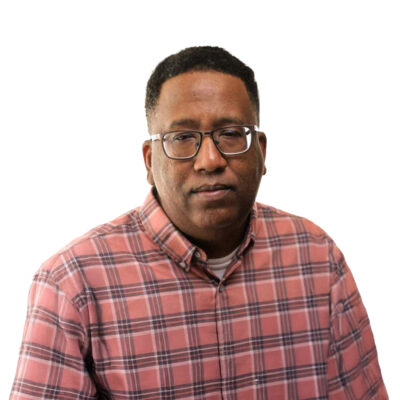 Darrell Hill, a Black man wearing glasses and a plaid shirt.