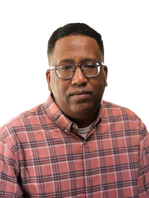 Darrell Hill, a Black man wearing glasses and a plaid shirt.