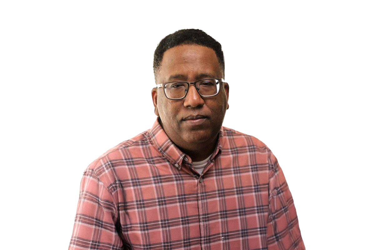 Darrell Hill, a Black man wearing glasses and a plaid shirt.
