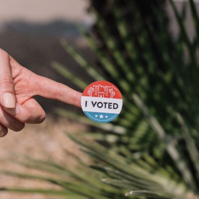 Hand with I Voted sticker