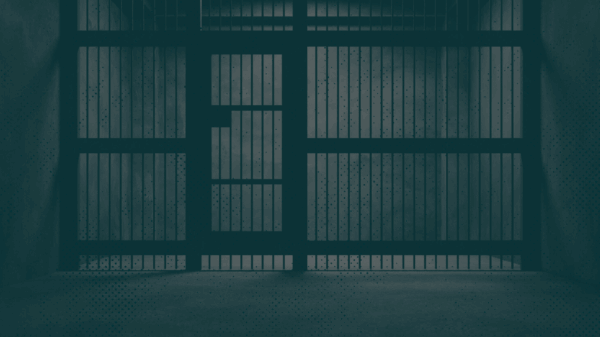 Image of jail cell with a green monochromatic overlay.