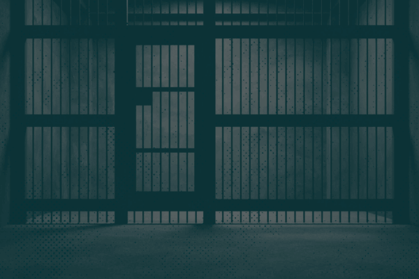 Image of jail cell with a green monochromatic overlay.