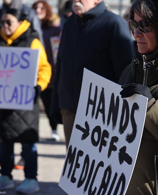 Demonstrators holding signs that read "HANDS OFF MEDICAID" protest the Trump administration's plan to roll back Medicaid expansion during a rally in front of the DuPage County Court House in Illinois.