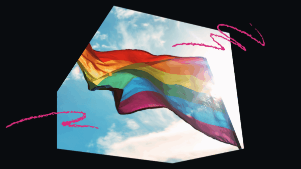 LGBTQ+ Flag flying on a clear, sunny day.