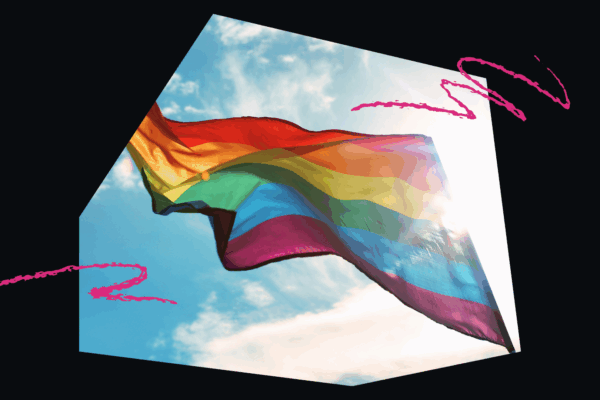 LGBTQ+ Flag flying on a clear, sunny day.