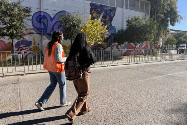 Yohana Oviedo, media coordinator of the Kino Border Initiative, and immigration attorney Marla Pacheco visit the government-run migrant shelter in Nogales, Sonora on Dec. 9.