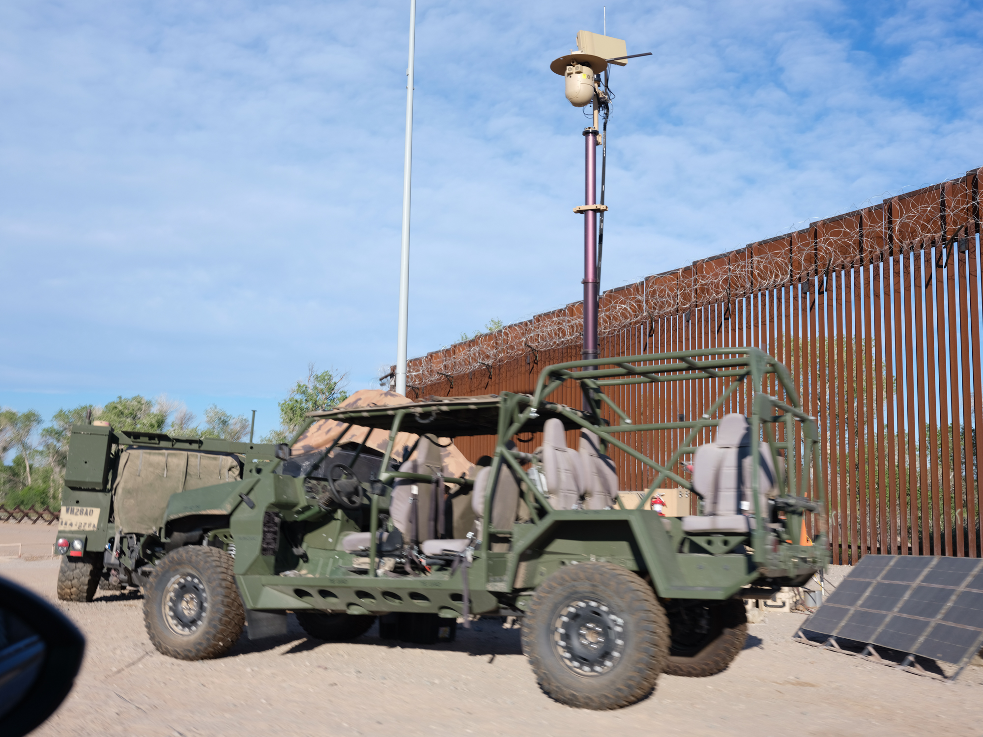 A military tactical vehicle sits empty at the point where the border wall ends along the Cocopah reservation.