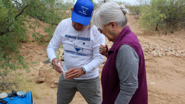 man and woman test water quality in the desert