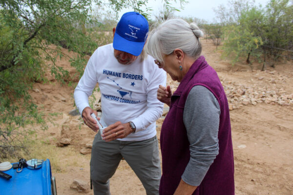 man and woman test water quality in the desert