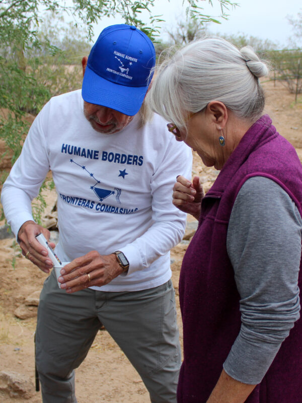 man and woman test water quality in the desert