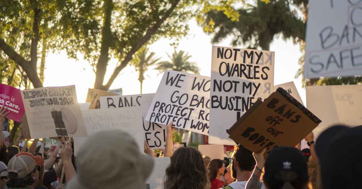 a crowd of reproductive rights supporters holding signs