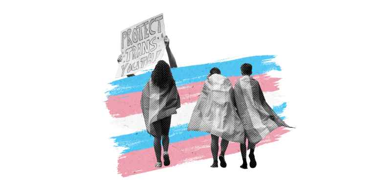 Two hands holding in front of a trans pride flag