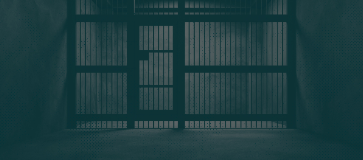 Image of jail cell with a green monochromatic overlay. 
